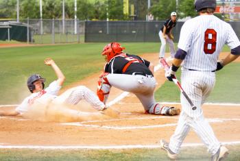 Player sliding into home plate, baseball tournaments in Gulf Shores