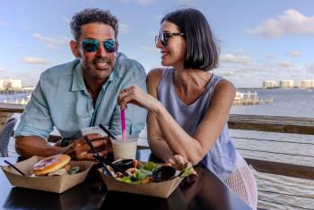 Couple dining at Avenue Pub waterfront restaurant in Orange Beach