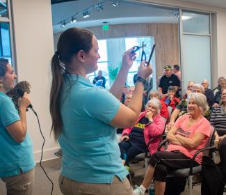 Lecture guests enjoy a special visit from Gulf Coast Zoo representatives and an owl