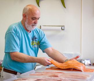 Man holding fresh seafood at Blalock Seafood in Orange Beach