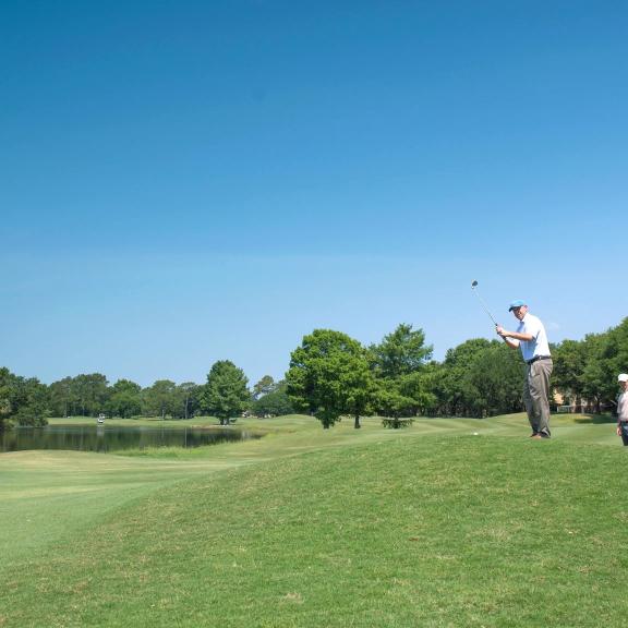 Golfers on the course at Craft Farms Golf Resort in Gulf Shores