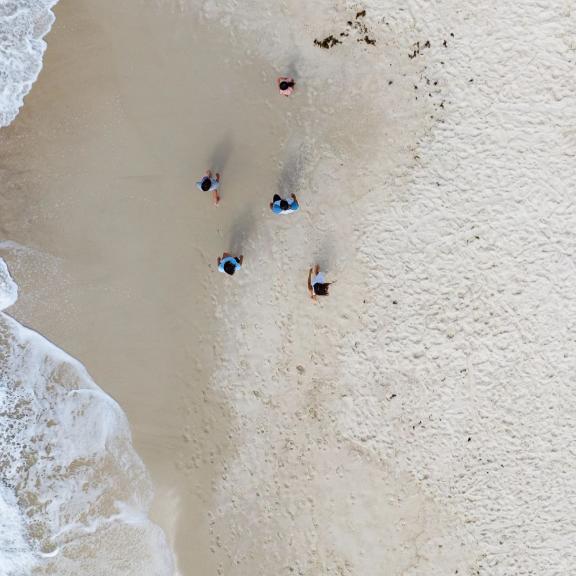 People walking along the shore in Orange Beach