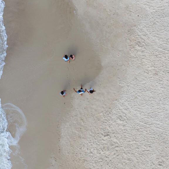 Family walking along the shore on the beach in Gulf Shores