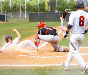 Player sliding into home plate, baseball tournaments in Gulf Shores