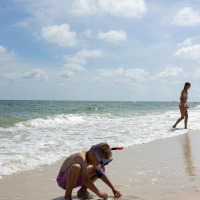 Child looking for shells on Alabama's Beaches